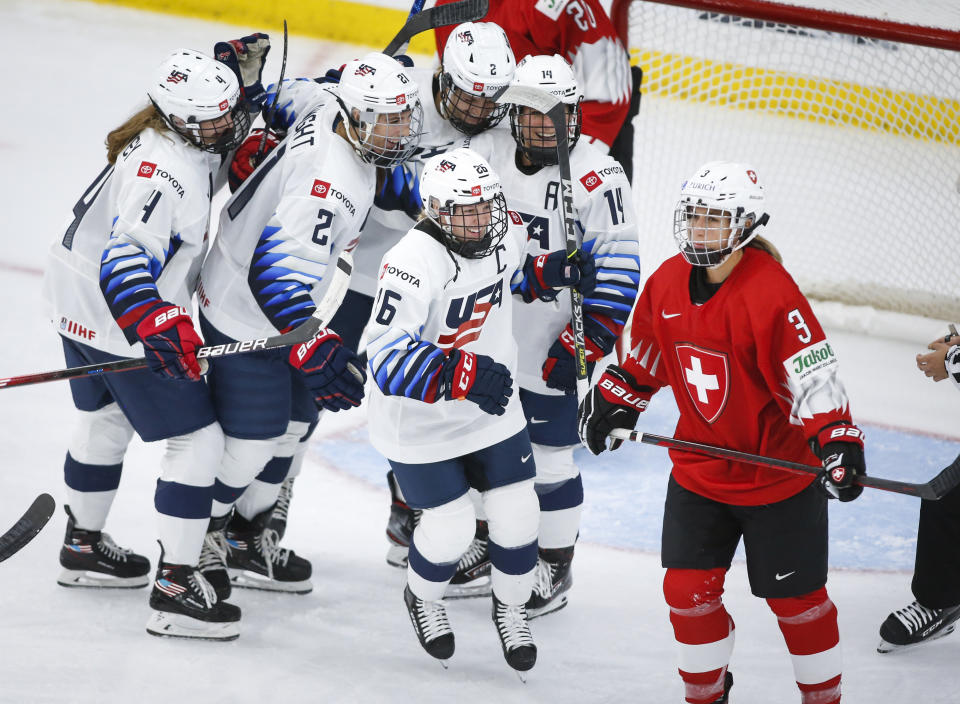 United States' Kendall Coyne Schofield (26) celebrates her goal as Switzerland's Sarah Forster skates away during the second period of an IIHF women's hockey championships game in Calgary, Alberta, Friday, Aug. 20, 2021. (Jeff McIntosh/The Canadian Press via AP)