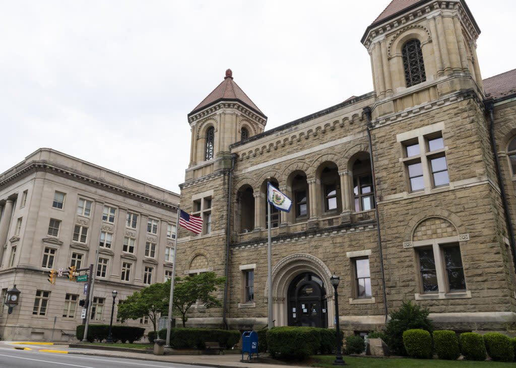 The Kanawha City Courthouse with an American and West Virginia state flag flying in front of it.