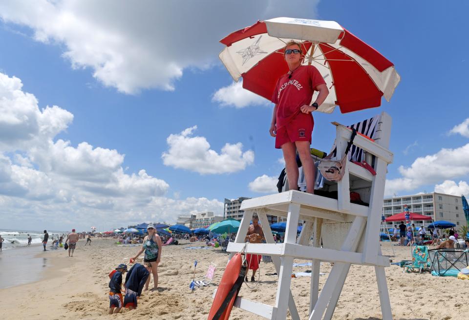 A lifeguard keeps watch of people playing in the ocean Saturday, July 3, 2021, in Ocean City, Maryland.