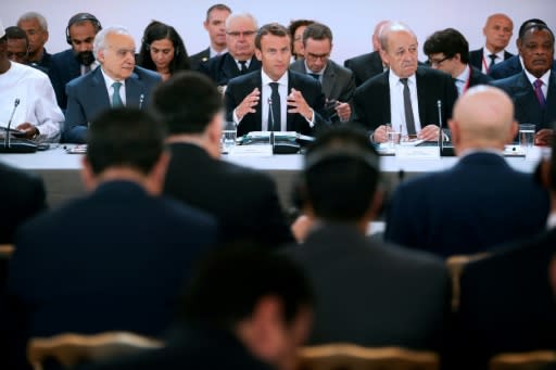 French President Emmanuel Macron, flanked by Foreign Minister Jean-Yves Le Drian (2R) and UN Special Envoy for Libya, Lebanese Ghassan Salame (L) speaks during an International conference on Libya at the Elysee Palace in Paris, on May 29, 2018