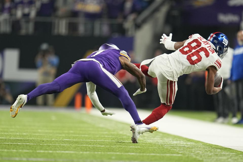 Minnesota Vikings' Patrick Peterson stops New York Giants' Darius Slayton during the second half of an NFL wild card football game Sunday, Jan. 15, 2023, in Minneapolis. (AP Photo/Abbie Parr)