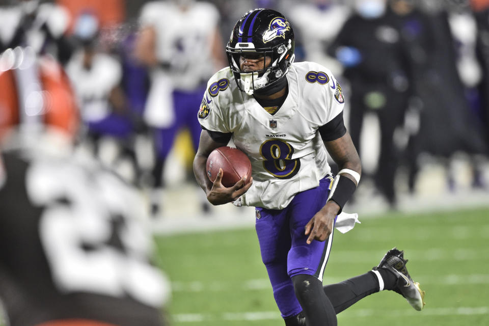 Baltimore Ravens quarterback Lamar Jackson (8) rushes for a 17-yard touchdown during the first half of an NFL football game against the Cleveland Browns, Monday, Dec. 14, 2020, in Cleveland. (AP Photo/David Richard)