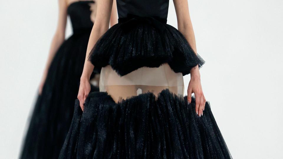  A model walks the runway during the Viktor & Rolf Haute Couture Spring/Summer show in a. black strapless gown