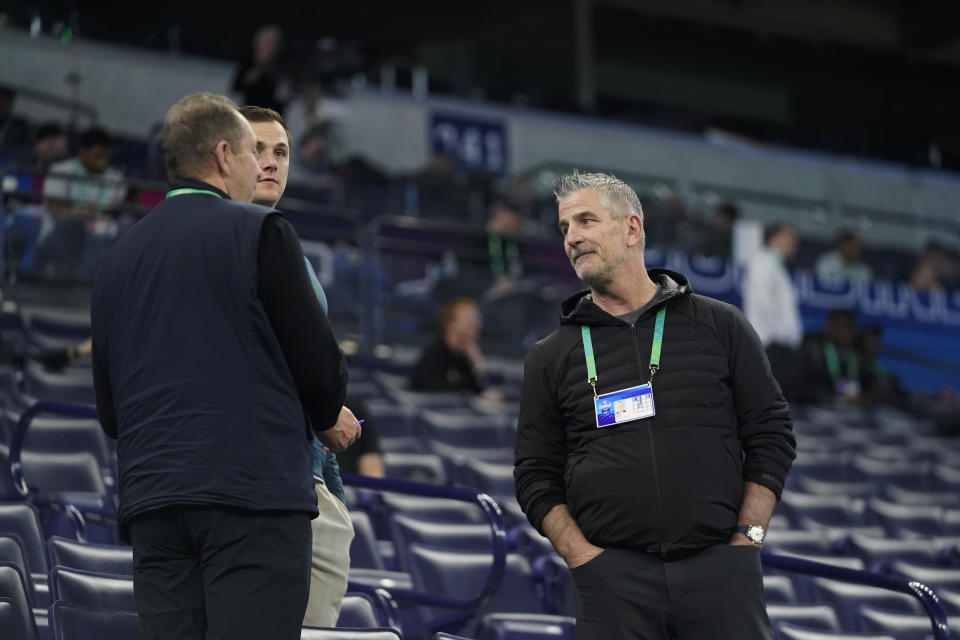Carolina Panthers head coach Frank Reich, right, watches as players run a drill at the NFL football scouting combine in Indianapolis, Saturday, March 4, 2023. The event is a moneymaking machine for the league, another interview/audition for players and a job fair for unemployed coaches looking for a new opportunity, but how necessary it is depends on who is answering the question. (AP Photo/Darron Cummings)