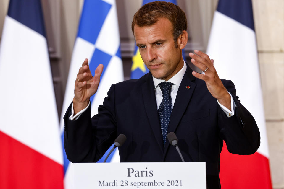 French President Emmanuel Macron speaks during the signing of a new defense deal at The Elysee Palace Tuesday, Sept. 28, 2021 in Paris. France and Greece announced on Tuesday a major, multibillion-euro defense deal including Athens' decision to buy three French warships. (Ludovic Marin, Pool Photo via AP)