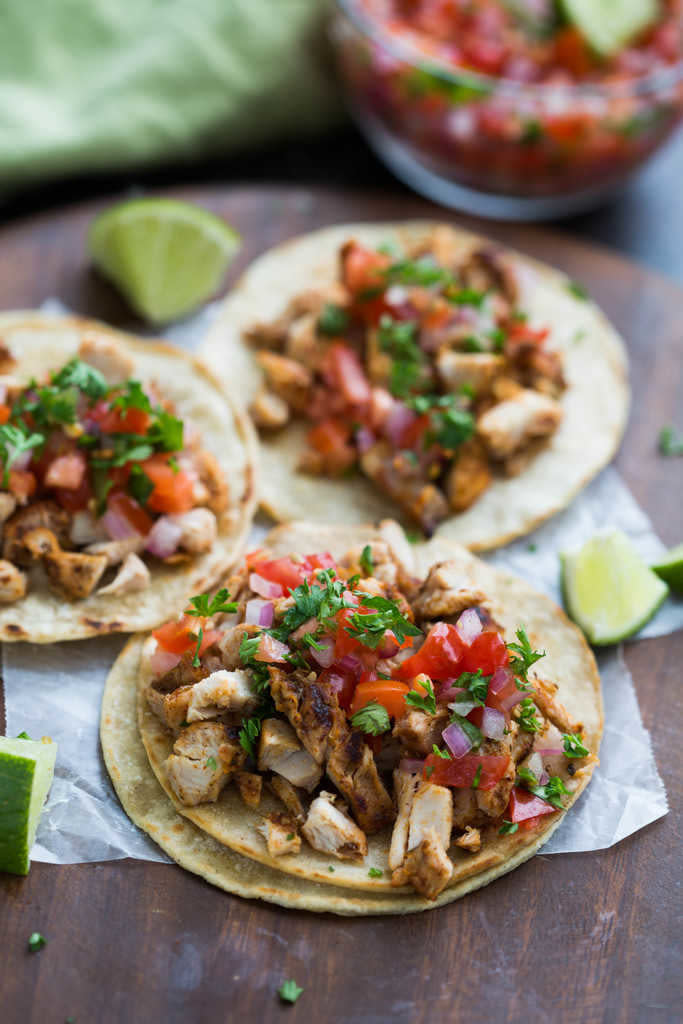 Chicken tacos with tomato and onion.