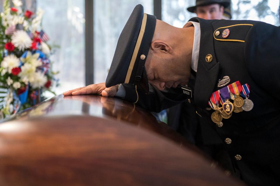 Sgt. Jose Burgos pauses for a moment at the casket of Vietnam veteran Peter Turnpu as several hundreds gather for a funeral Friday, Jan. 18, 2019 in Wrightstown, N.J.