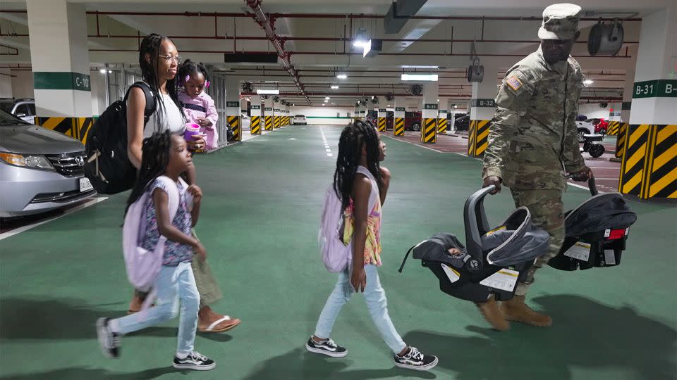 US Army Sgt. Terry Cook and his wife, Tyrese, walk with their five children to their new home in Korea, Camp Humphreys. - Charlie Miller/CNN