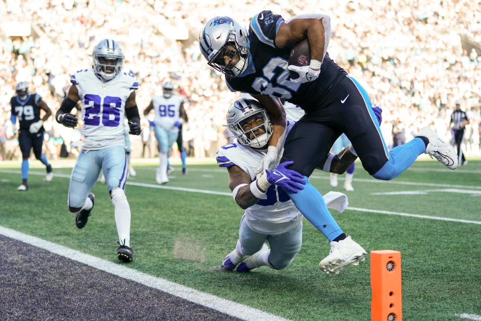 Carolina Panthers tight end Tommy Tremble scores past Dallas Cowboys safety Juanyeh Thomas during the second half of an NFL football game Sunday, Nov. 19, 2023, in Charlotte, N.C. (AP Photo/Erik Verduzco)