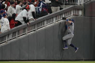 Los Angeles Dodgers left fielder AJ Pollock tries to catch a foul ball by Atlanta Braves' Terrance Gore during gate fifth inning in Game 2 of baseball's National League Championship Series Sunday, Oct. 17, 2021, in Atlanta. (AP Photo/Ashley Landis)