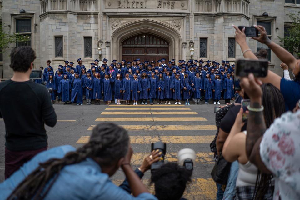 Photographers and family members take photos of The School at Marygrove's first graduating class in front of the Liberal Arts building at the end of the seniors' last day at the Detroit school on Friday, May 19, 2023.