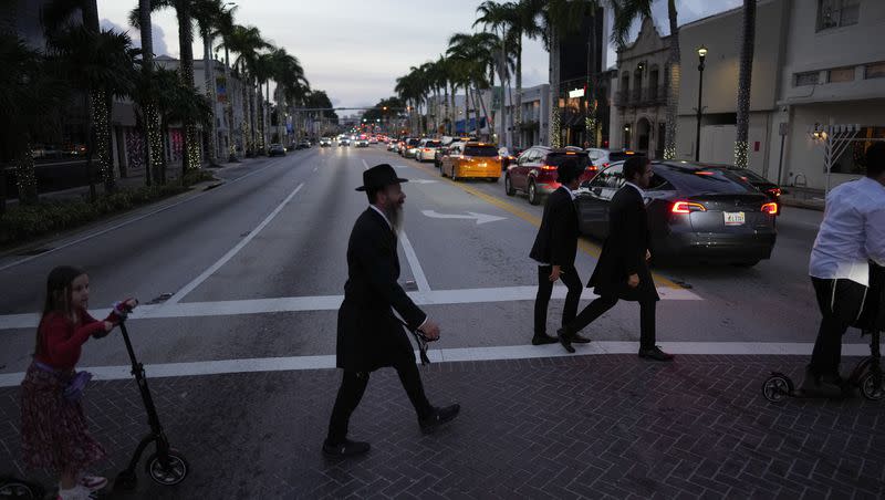 Jewish men and boys walk to synagogue for Shabbat service, in Miami Beach, Fla., Friday, Dec. 1, 2023. Daily life for many Jews has been upended by the surprise attack on Oct. 7 in Israel and by the rise in antisemitism worldwide during the ensuing war.