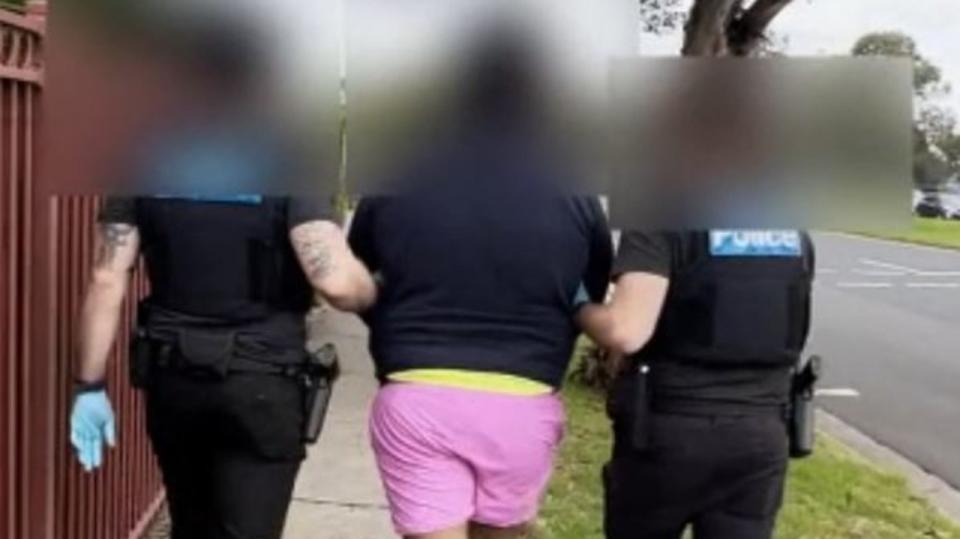 Police released video of the arrest, showing a man being led from a home in hot pink shorts. Picture: Victoria Police.