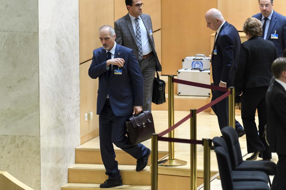 Syrian chief negotiator Bashar al-Jaafari, left, Ambassador of the Permanent Representative Mission of Syria to UN New York, leaves after he welcomed the delegations at the opening of a new round of Syria peace talks, at the European headquarters of the United Nations in Geneva, Switzerland, Thursday, Feb. 23, 2017. Syria's government and the armed opposition were due to meet at the UN's Geneva headquarters on 23 February to begin roundtable discussions mediated by UN Syria envoy Staffan de Mistura. (Martial Trezzini/Keystone via AP)