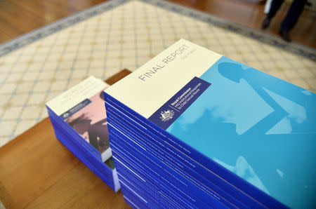 The volumes of the Final Report of the Royal Commission into Institutional Responses to Child Sexual Abuse sit on the table before the signing ceremony of the release of the papers at Government House in Canberra, Australia, December 15, 2017. Royal Commission into Institutional Responses to Child Sexual Abuse/Handout via REUTERS