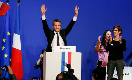 Emmanuel Macron, head of the political movement En Marche ! (Onwards !) and candidate for the 2017 presidential election, reacts on stage before he delivers a speech during a campaign rally in Besancon, France, April 11, 2017. REUTERS/Robert Pratta