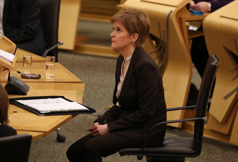 First Minister Nicola Sturgeon reacts as she delivers a statement at Holyrood, Edinburgh, announcing that Scotland will be placed in lockdown from midnight for the duration of January with a legal requirement to stay at home except for essential purposes.