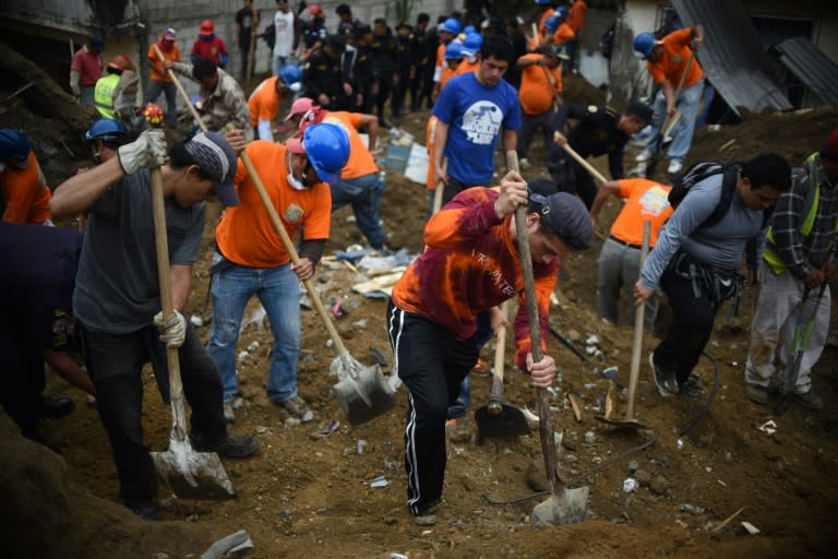 Volunteers take part in the search for victims in the village of El Cambray II, some 15 km east of Guatemala City, on October 3, 2015 after a landslide