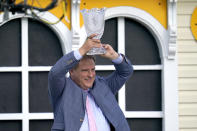 Trainer Michael Trainer Michael J. Maker holds a trophy after his horse, Army Wife, won the Black-Eyed Susan Stakes horse race at Pimlico Race Course, Friday, May 14, 2021, in Baltimore. (AP Photo/Julio Cortez)