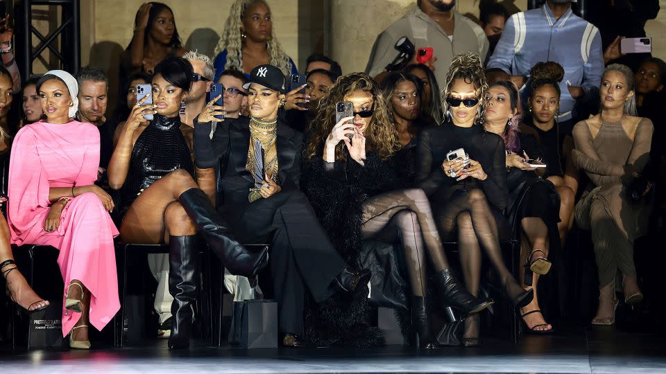 From left: Halima Aden, Coco Jones, Teyana Taylor, Winnie Harlow, and LaLa Anthony sit front row at the PrettyLittleThing x Naomi Campbell runway show. - Dimitrios Kambouris/Getty Images