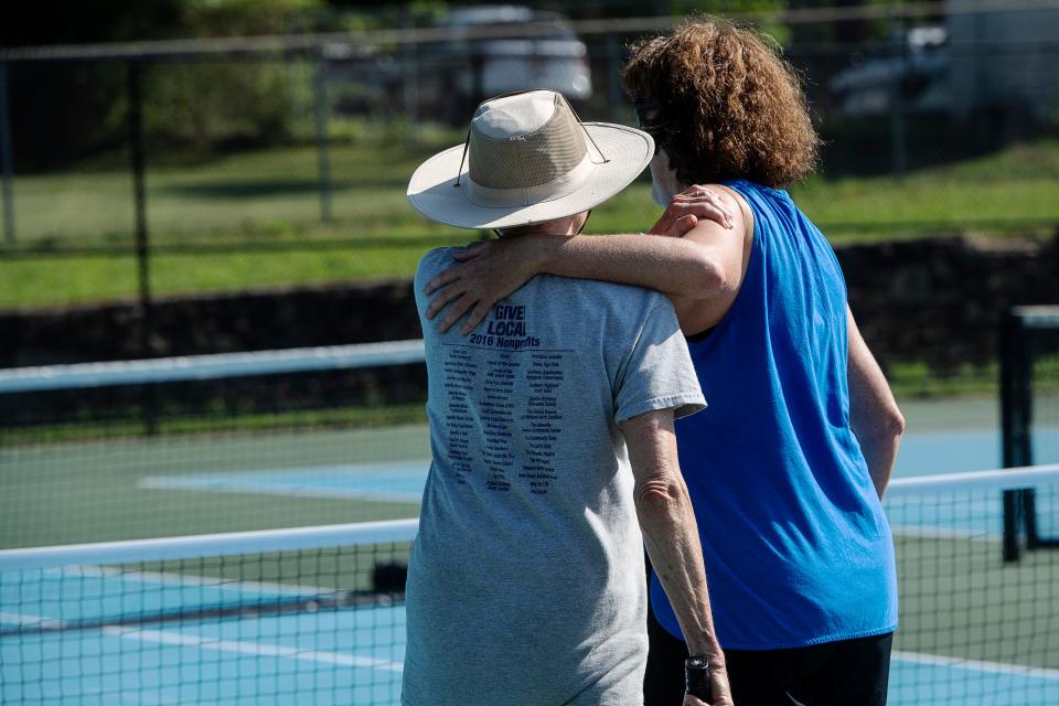 Melinda Splain, right, puts her arm around Donna Kelly during a pickleball game at Murphy-Oakley Park in Asheville June 17, 2022.