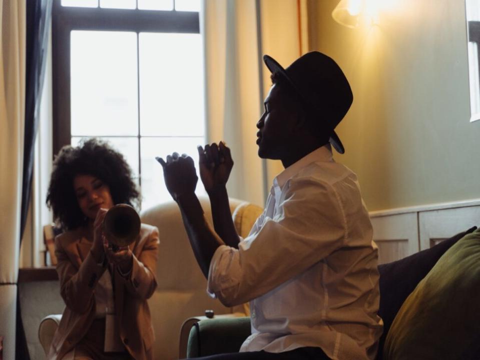 Musician Showing His Friend How to Hold a Trumpet
