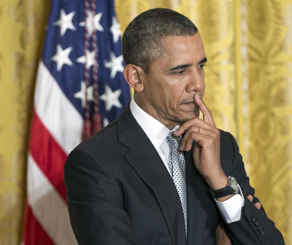 In this April 3, 2014, photo, President Barack Obama listens on stage before speaking about the shooting at Fort Hood, during an event welcoming members of the U.S. teams from the 2014 Winter Olympic and Paralympic Winter Games in Sochi, Russia in the East Room of White House in Washington. The roller coaster of health care enrollment behind him, Obama is using a lull between foreign travel to refocus on his economic agenda, using executive actions to push for greater gender pay equality and to promote better technical skills for U.S. students.(AP Photo/Pablo Martinez Monsivais)