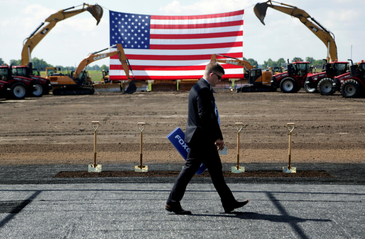 Heavy machinery and the American flag are seen before the arrival of U.S. President Donald Trump as he participates in the Foxconn Technology Group groundbreaking ceremony for its LCD manufacturing campus, in Mount Pleasant, Wisconsin, U.S., June 28, 2018.  REUTERS/Darren Hauck     TPX IMAGES OF THE DAY