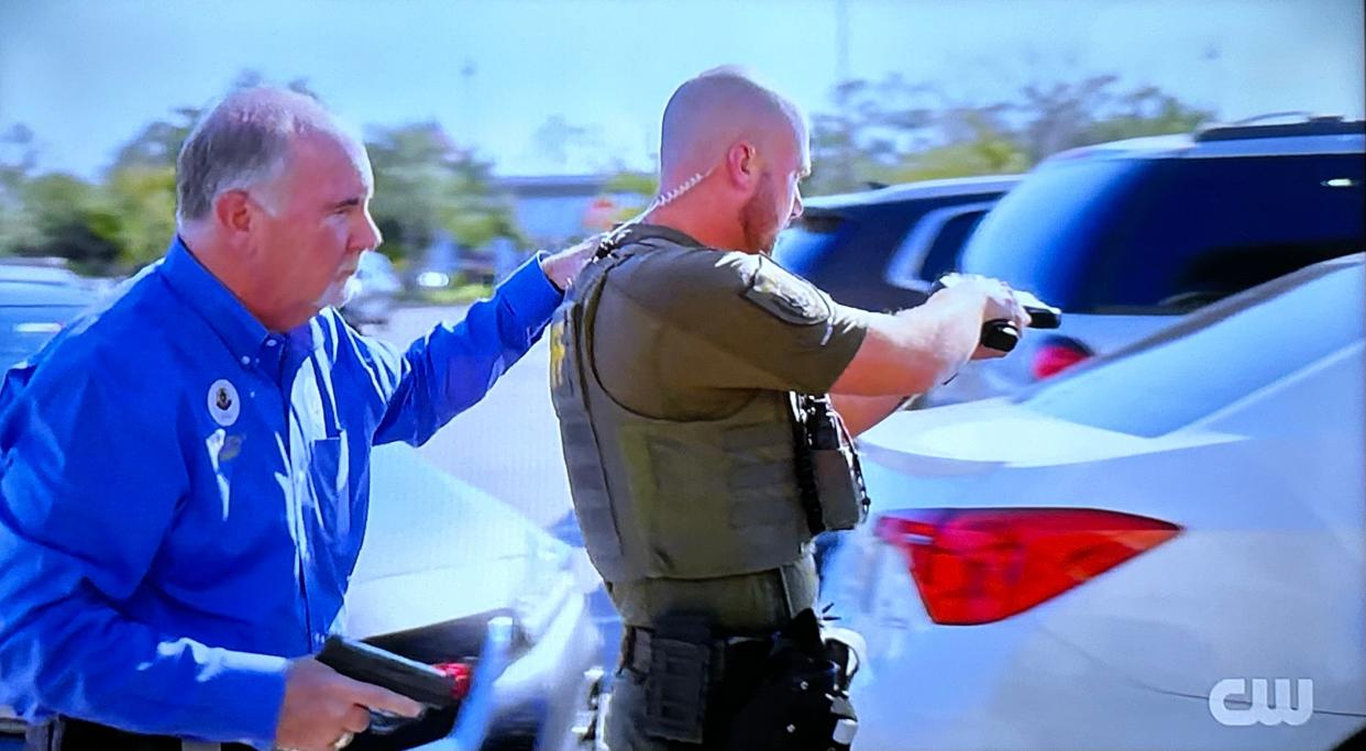 In a photo of a video from "Police 24/7" on The CW channel, Flagler County Sheriff Rick Staly backs up a deputy during the arrest of a man accused of shoplifting more than $1,000 worth of shaving razors from Target on State Road 100.