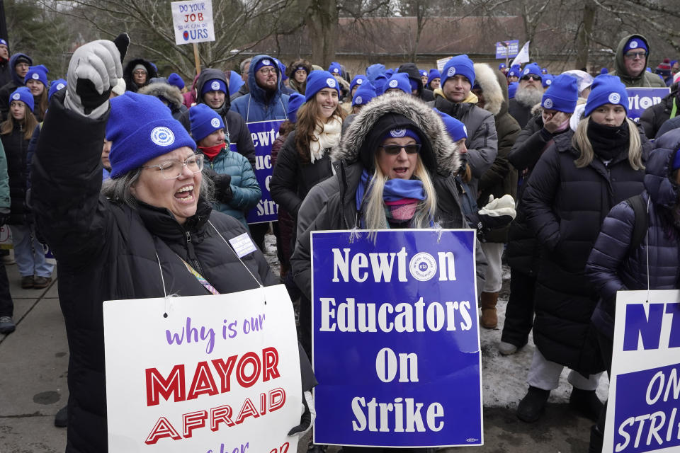 Striking Newton teachers and supporters display placards and chant during a rally, Tuesday, Jan. 30, 2024, outside Newton City Hall, in Newton, Mass. Contract negotiations between the Newton Teachers Association and the city's School Committee continued Tuesday. (AP Photo/Steven Senne)