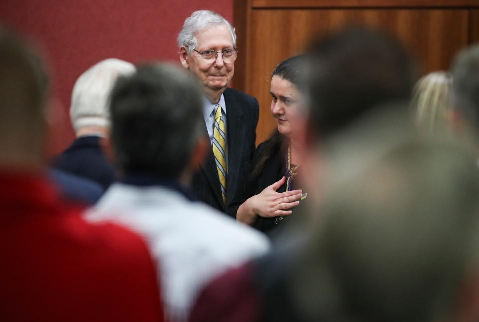 Sen. Mitch McConnell smiles as he stands with Ukranian ambassador Oksana Markarova after they both urged an audience of around 100 people at the University of Louisville support for Ukraine Monday. Oct. 30, 2023.