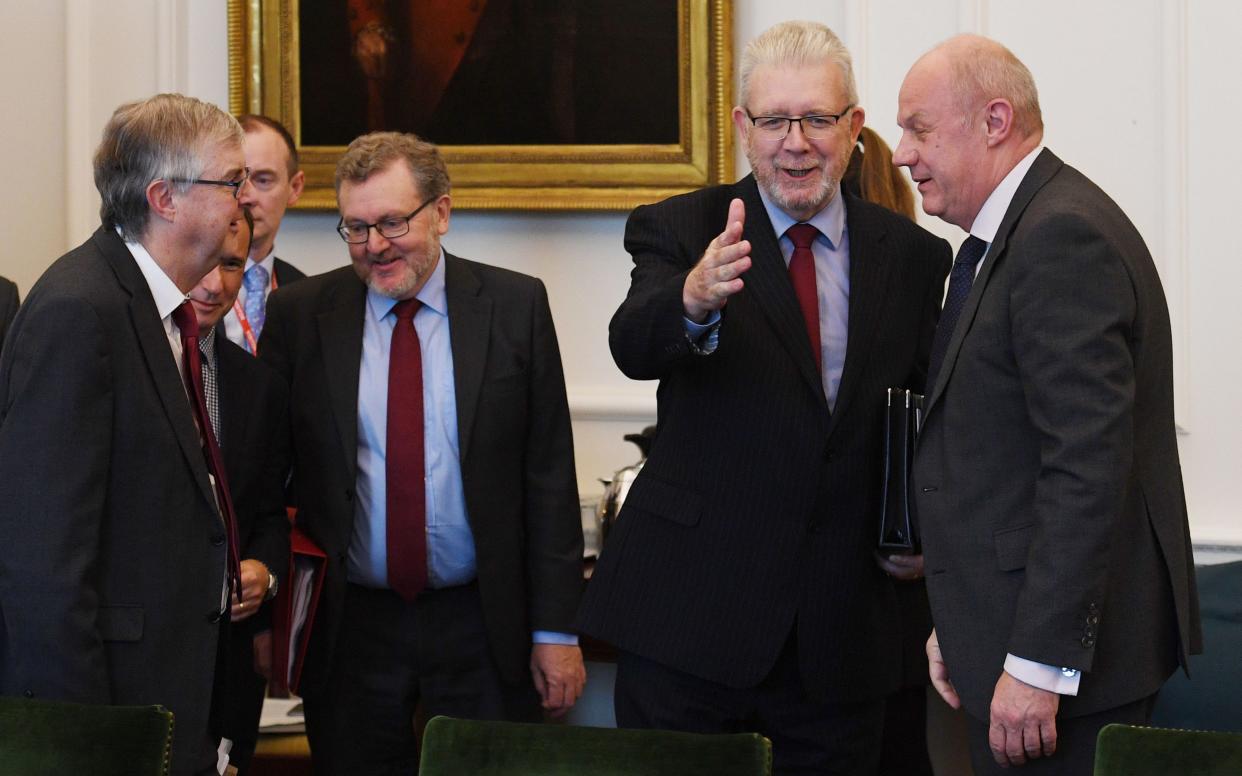 Michael Russell (second right) is greeted by Damian Green - PA