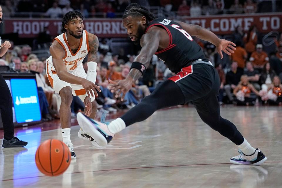 Texas guard Tyrese Hunter slips a pass by Texas Tech's Joe Toussaint during the first half Saturday night at Moody Center. Texas Tech rolled to a 78-67 win.