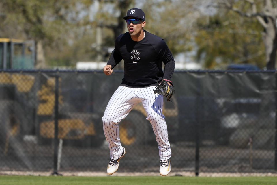 New York Yankees second baseman Gleyber Torres leaps while waiting to field a ground ball during a baseball spring training workout Wednesday, Feb. 21, 2024, in Tampa, Fla. (AP Photo/Charlie Neibergall)