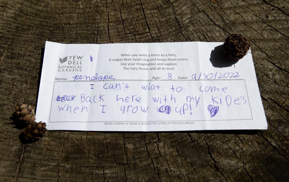 Children and adults alike leave messages for the residents of Fairy Forest at Yew Dell Botanical Gardens. This one, by 8-year-old Penelope, tells the fairies she will be back with her "kide's" when she grows up. 