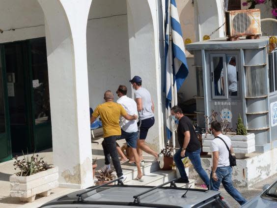 Manchester United captain Harry Maguire, wearing cap, arrives at court in Syros, Greece (EPA)