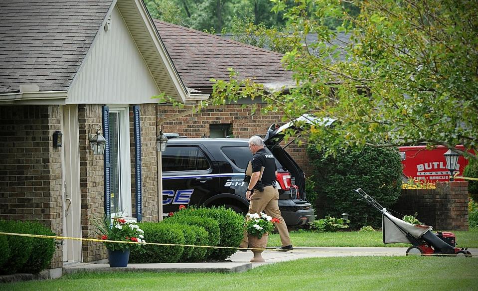 Police investigate a shooting Friday, Aug. 5, 2022, in Butler Township, Ohio.  Authorities say four people were shot to death in the Ohio suburb and a man considered armed and dangerous is being sought.