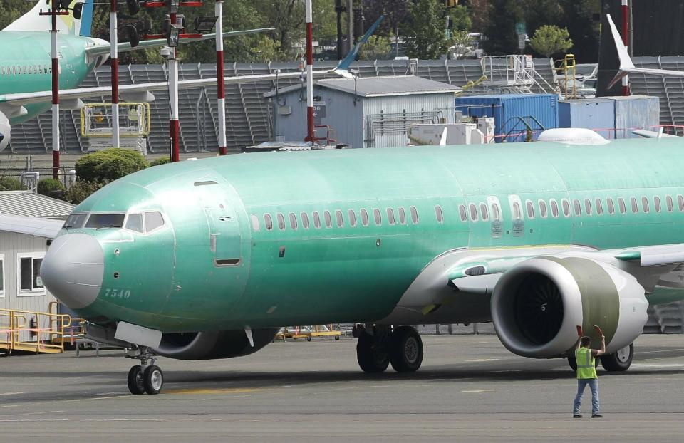 FILE - In this May 8, 2019, file photo a worker stands near a Boeing 737 MAX 8 jetliner being built for American Airlines prior to a test flight in Renton, Wash. United Airlines said Friday, July 12, that it now expects to cancel more than 8,000 flights through October because of the grounding of its Boeing 737 Max planes. (AP Photo/Ted S. Warren, File)