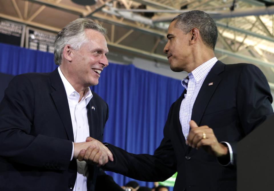 U.S. President Obama shakes hands with Terry McAuliffe at his campaign event for Governor in Arlington