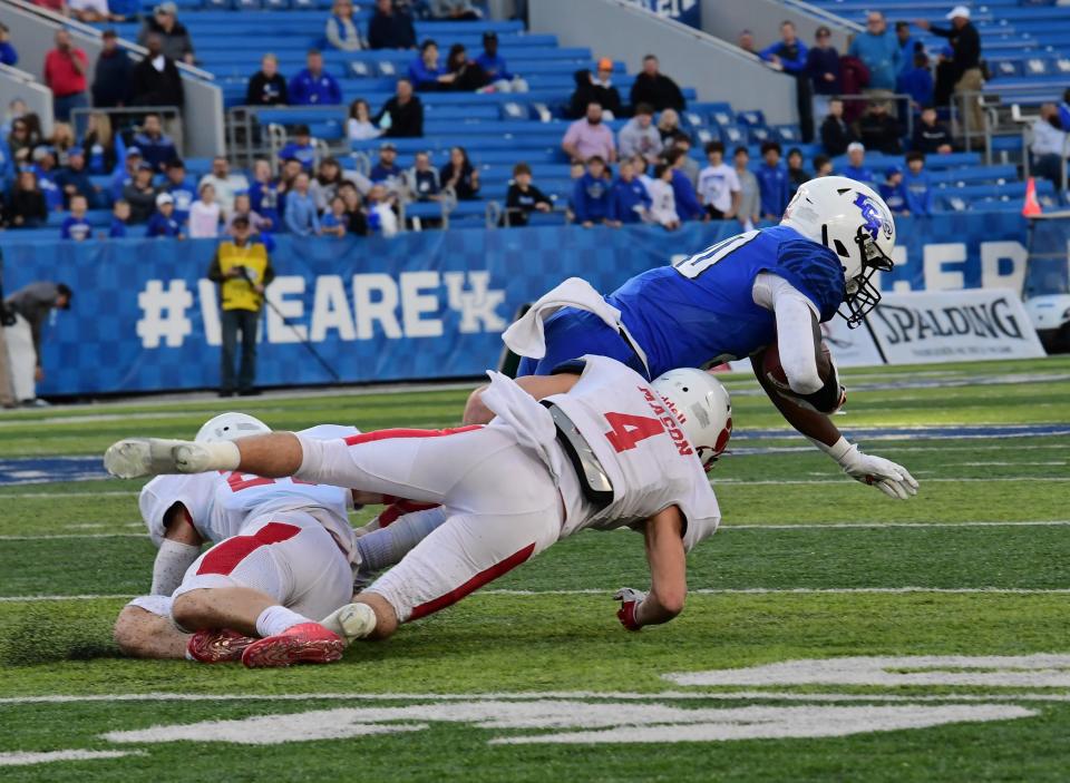 Parker Mason (4) of Beechwood drops Xavier Brown of LCA to prevent the Eagles from gaining a first down at the 2021 KHSAA Class 2A state football championship, Dec. 3, 2021.