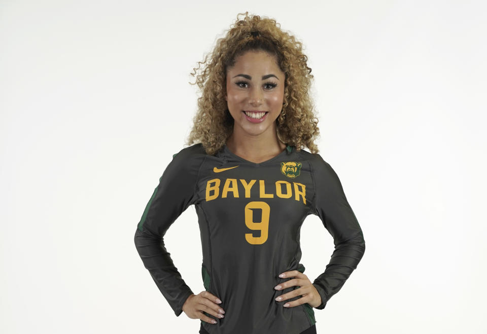 In this photo provided by Baylor University, Payton Washington poses in an undated photo wearing Baylor University attire. Washington was one of two cheerleaders shot and wounded by a man in a Texas supermarket parking lot after one of them said she mistakenly got into his car thinking it was her own. (Baylor University via AP)