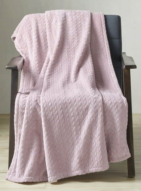 large pink plush throw blanket on a chair