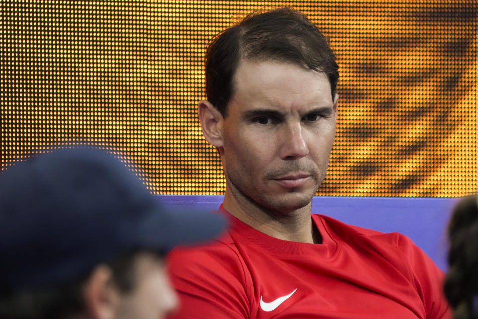 Spain's Rafael Nadal sits in the team box as compatriot Spain's Jessica Bouzas Maneiro plays Australia's Olivia Godecki in their Group D match at the United Cup tennis event in Sydney, Australia, Tuesday, Jan. 3, 2023. (AP Photo/Mark Baker)