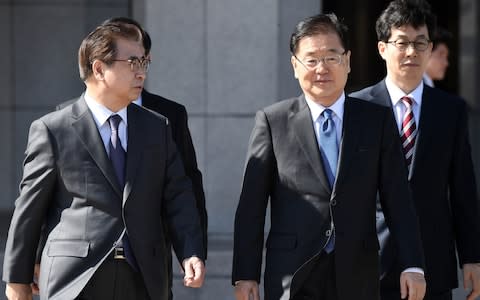 Chung Eui-Yong, second right, head of the presidential National Security Office, and Suh Hoon ,left, the chief of the South's National Intelligence Service, before boarding a plane to the North - Credit:  Getty