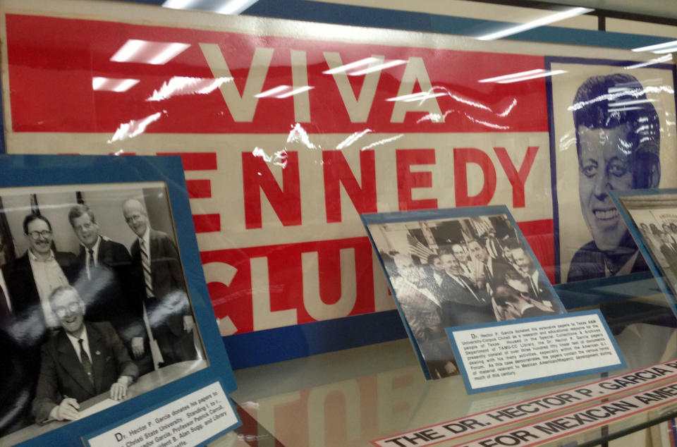 In this March 14, 2013 photo, old Viva Kennedy! campaign buttons of civil rights leader and G.I. Forum founder Dr. Hector P. Garcia, lower left, are shown at the Garcia exhibit at Texas A&M-Corpus Christi, Texas. The coastal Texas city's deep roots in Mexican American history is often overlooked as visitors mainly come here for a quick beach getaway. (AP Photo/Russell Contreras)