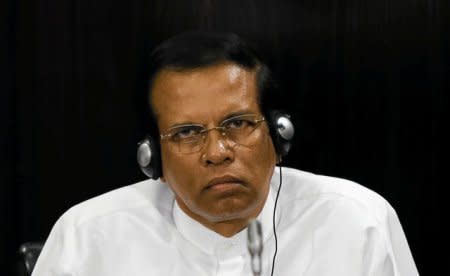 FILE PHOTO: Sri Lanka's President Maithripala Sirisena listens to a speech during a Parliament session marking the  70th anniversary of Sri Lanka's Government, in Colombo, Sri Lanka October 3, 2017. REUTERS/Dinuka Liyanawatte/Files