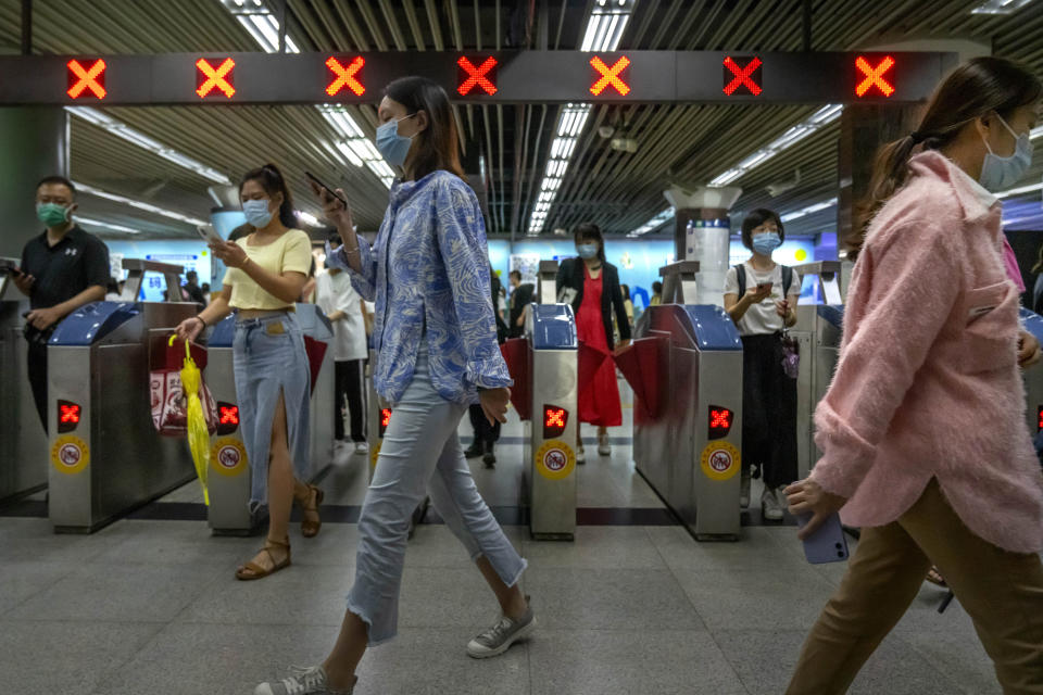 Commuters walk through a subway station during the morning rush hour in the central business district in Beijing, Tuesday, Aug. 9, 2022. China's 11 million university graduates are struggling in a bleak job market this summer as repeated shutdowns under China's anti-COVID lockdowns forced companies to retrench and driven many restaurants and other small employers out of business. (AP Photo/Mark Schiefelbein)