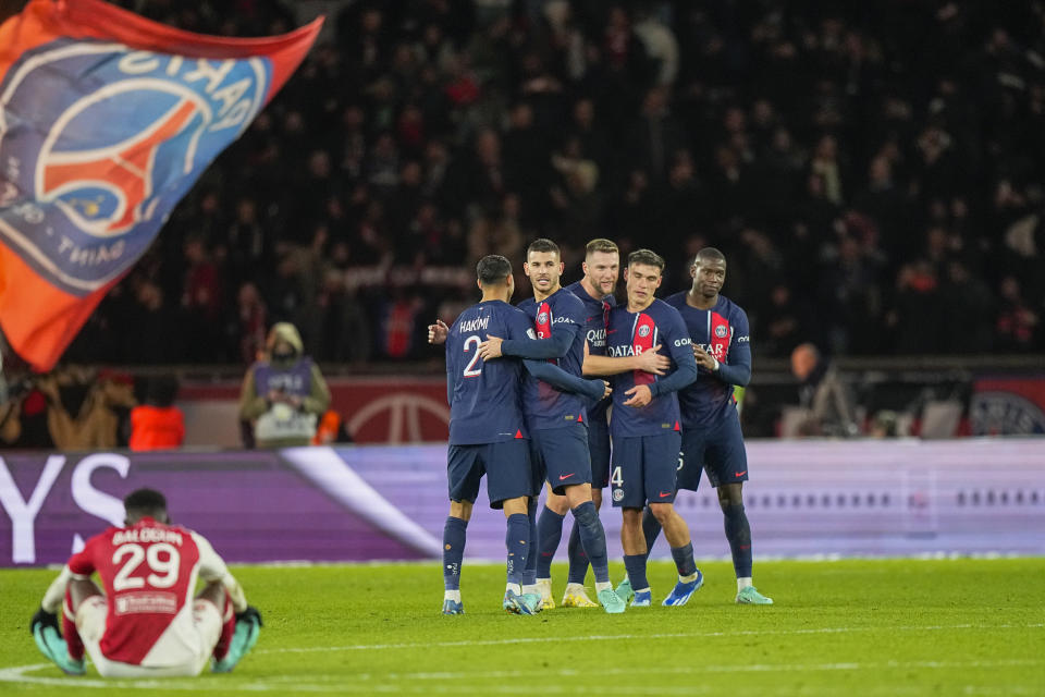 PSG's players celebrate at the end of the French League One soccer match between Paris Saint-Germain and Monaco, at the Parc des Princes stadium in Paris, France, Friday, Nov. 24, 2023. (AP Photo/Michel Euler)