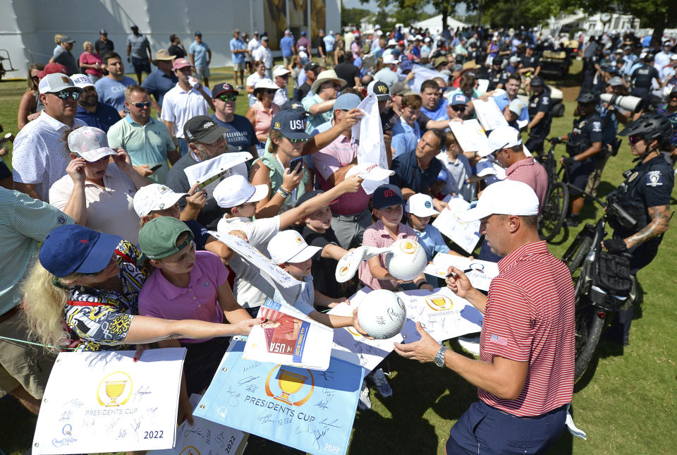 United States Justin Thomas, bottom right, stops to sign autographs for fans following during practice for the Presidents Cup golf matches at the Quail Hollow Club, Tuesday, Sept. 20, 2022, in Charlotte, N.C. (Jeff Siner/The Charlotte Observer via AP)