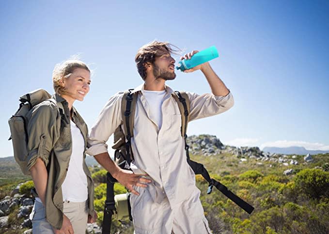 two people on a hike; one is using a blue water bottle